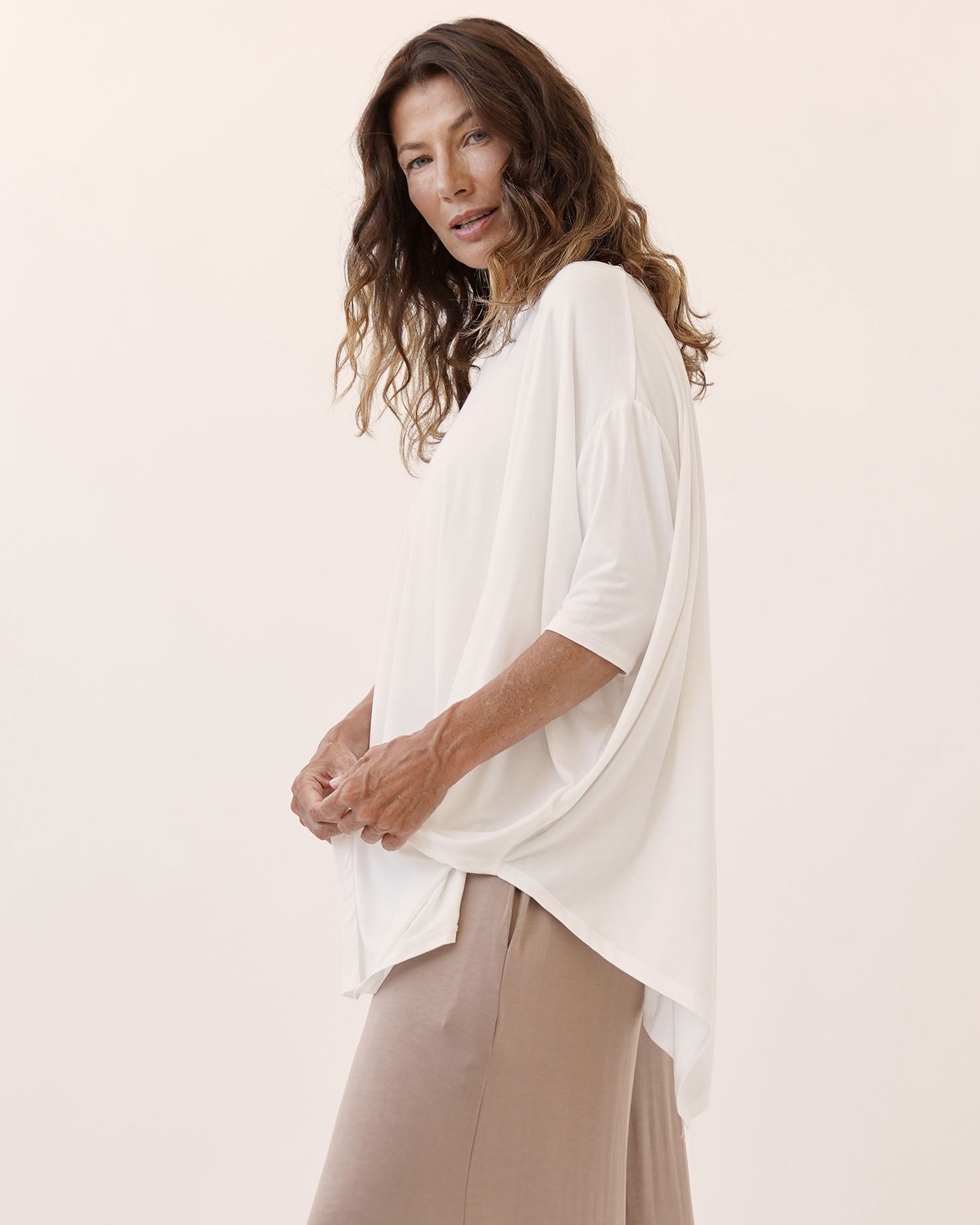 A bamboo poncho tunic top with boat neckline and edgy hemline